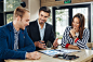 Small group of young people at a business meeting in a cafe