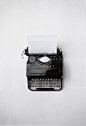 A vintage analogue typewriter with a white plain paper