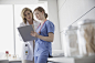 Doctor and nurse reviewing medical chart in clinic by Hero Images  on 500px