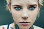 portrait of young nordic girl, age 25, freckled skin, neck tatoo, blue eyes, blond hair, 35mm lens, photography, ultra details