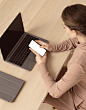 woman-sitting-her-laptop-using-smartphone