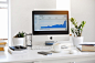 Silver Imac Displaying Line Graph Placed on Desk