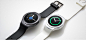 Gear S2 in dark gray and silver laid out on flat surface