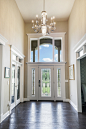 Entryway - mid-sized transitional dark wood floor entryway idea in Cleveland with beige walls and a white front door