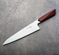 The 205mm satin finished 52100 carbon steel blade features a slight convex grind and thin, sharp edge matched in beauty by the old-grown cocobolo handle.