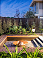 Inspiration for a mid-sized contemporary full sun backyard landscape in Melbourne with a fire feature and gravel.