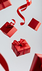 Red gift boxes on a white background, with a red ribbon, a red paper box flying in the air, in a flat design, high-resolution photography, high-key lighting, high level of detail, high quality, high contrast, in PNG format, a wide-angle shot, a trending c