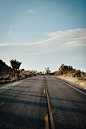 gray asphalt road under blue sky during daytime