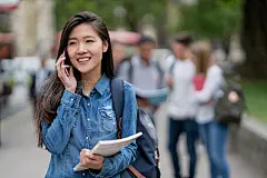 Asian student outdoors talking on the phonePortrait of an Asian student outdoors talking on the phone - lifestyle concept
