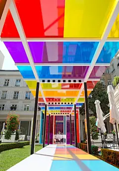 daniel buren creates a chromatic landscape in the gardens of hotel le bristol paris: