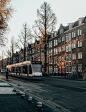 white and yellow tram on road near brown building during daytime