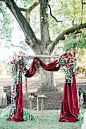 deep red velvet draped wedding arch: 