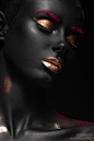 Black skin : fashion portrait of a dark-skinned girl with color make-up.Beauty face. Picture taken in the studio on a black background.
