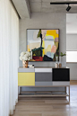 contemporary colorful furniture | large abstract painting in hallway | concrete walls | residential interior design ideas