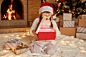 extremely-excited-surprised-little-girl-wearing-white-sweater-santa-claus-hat-opens-gift-box-with-something-glowing-sitting-floor-near-christmas-tree-present-boxes-fireplace