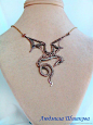 其中可能包括：a necklace with a dragon on it is displayed on a mannequin neckline