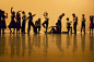 Dancers stretching in rehearsal on stage - stock photo