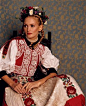 Hungary Bride Rhapsodies in bold embroidery, heart-stealing maidens inspired by Old-World folk customs wear layers of clothing topped with a beaded, paprika-colored velvet vest and a finely pleated silk apron. Rows of  braids, and a wildflower-and-heather