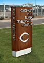 A freestanding monument constructed of water jet cut Cor-Ten steel and brushed aluminum flat cutout letters helps direct players to the Reds development complex.: 
