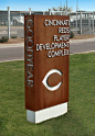 A freestanding monument constructed of water jet cut Cor-Ten steel and brushed aluminum flat cutout letters helps direct players to the Reds development complex.: