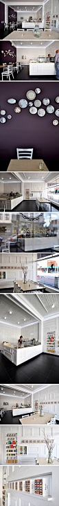 #贝美装饰（大连）有限公司#　By Josephine是一家位于墨尔本的法式蛋糕店，法国设计师Anne-Sophie Poirier(Sasufi) 为他们设计了位于墨尔本不伦瑞克2012年底开业的新店面空间。

设计师希望以内部空间设计反映两个主旨：简约和对比。

　　参考传统巴黎精品店内墙面镶板的形式，设计师将收集来的旧木门整体涂成白色并拼凑出整个墙面，大面积的白色衬托出鲜艳的马卡龙和Kusmi茶。明亮的墙壁仿佛飘离于深色地面和原有模压天花板之外，给空间带来整体的轻盈感觉。而与之相对比的是一个悬挂着各