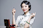 Young beautiful woman in traditional cheongsam with perfume