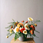 orange ranunculus, poppies, and white peonies