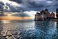 In Lake Geneva is the Chillon Castle, which is also known as the Chateau de Chillon. This castle is comprised of 100 individual buildings that were connected one by one over time. The history of the Chillon Castle dates back more than 800 years.