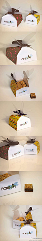 由西班牙设计师Queralt Antú Serrano设计的Borinots 糕点包装盒。Borinots盒子顶端有只大蜜蜂呢，标明这糕点连蜜蜂都吸引过来了。这是一种由牛奶巧克力做的松软蛋糕，里面镶满了榛子奶油和杏仁，这盒子有两种尺寸，分别装18片和32片的蛋糕。