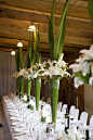 Spectacular tall centerpieces of green aspidistra leaves and white lilies.: 