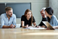 Business people reviewing paperwork in meeting by Caia Images on 500px