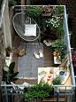 You can make a small balcony feel cozy by installing some hanging planters, a comfy seat and a small rug.: 