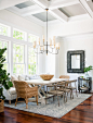 Example of a large beach style medium tone wood floor dining room design in Other with white walls and no fireplace