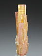 libutron:

Tourmaline | ©Crystal Classics
Nuristan Province, Afghanistan. 
A parallel arrangement of Tourmaline crystals with an unusual orange-yellow color, zones of pink, and creamy white areas of Mica.