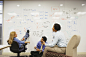 Businesspeople having a meeting in front of a whiteboard wall by Gable Denims on 500px