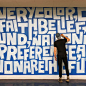 Man painting a blue and white mural