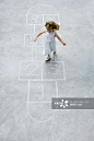 Little girl playing hopscotch, high angle view创意图片素材 - PhotoAlto Agency RF