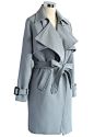 Textured Belted Trench Coat in Grey : Cool grey! Step out in this subtly hued trench coat with its textured belt, storm flap, exaggerated lapels and cuffs decorating the sleeves and shoulders. The silhouette screams Sherlock Holmes without losing any of i