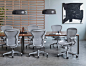 Contemporary conference room with concrete floors, slatted wood wall, abstract art on the wall, and six new Aeron Chairs around Layout Studio Tables