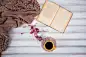 Coffee cup and open book close up. Winter and Christmas