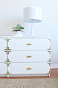 You can give IKEA’s ultra-simple Malm drawers the look of an expensive campaign dresser by simply adding brass corner braces and a brass pulls to each drawer. Blogger Jackie DiCi transformed the flat-pack furniture in her Miami home, and it now has much m
