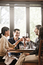 Friends drinking red wine together in restaurant by Gable Denims on 500px