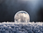 A macro view of a frozen winter ball on the cold winter ground.