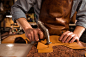 Close up of a cobbler working with leather