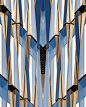 Vertical shot of a symmetrical blue glass and concrete building