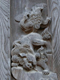 This may contain: an animal carved into the side of a wooden wall
