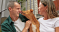Brown Cattle Dog Licking Couple
