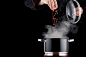 Modern chef in professional uniform adding spice to steaming pot by Kamil Zabłocki on 500px