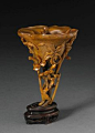 A fine and rare carved rhinoceros horn libation cup. 17th-18th Century. photo Bonhams