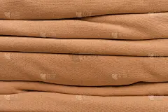 折叠橘色织物。材料。格子。表。